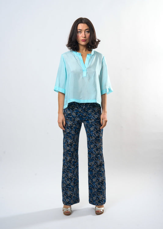Woman wearing the Maria Cecilia Pale Blue Silk Tee, front view