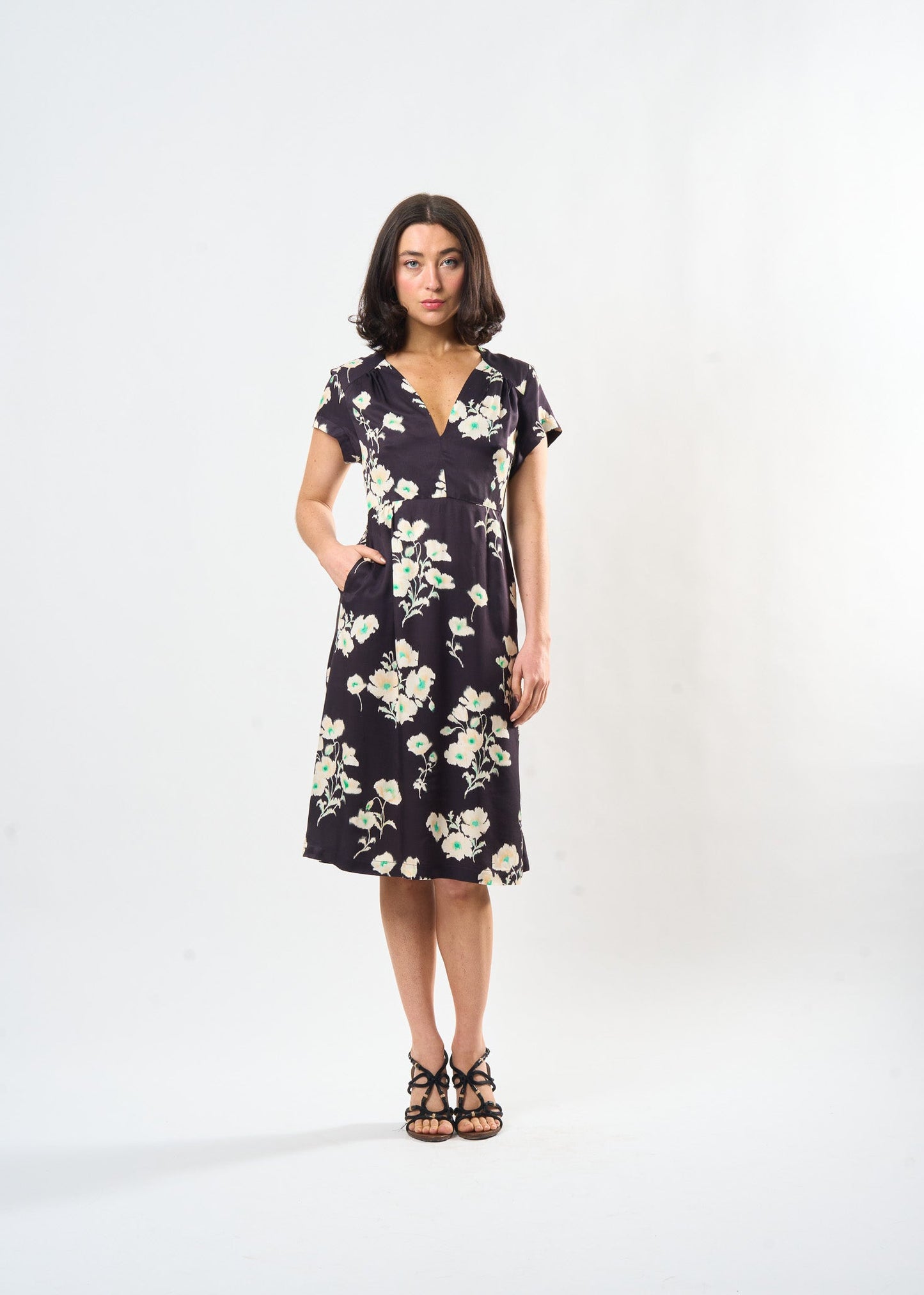 Woman wearing a floral dress on a white background