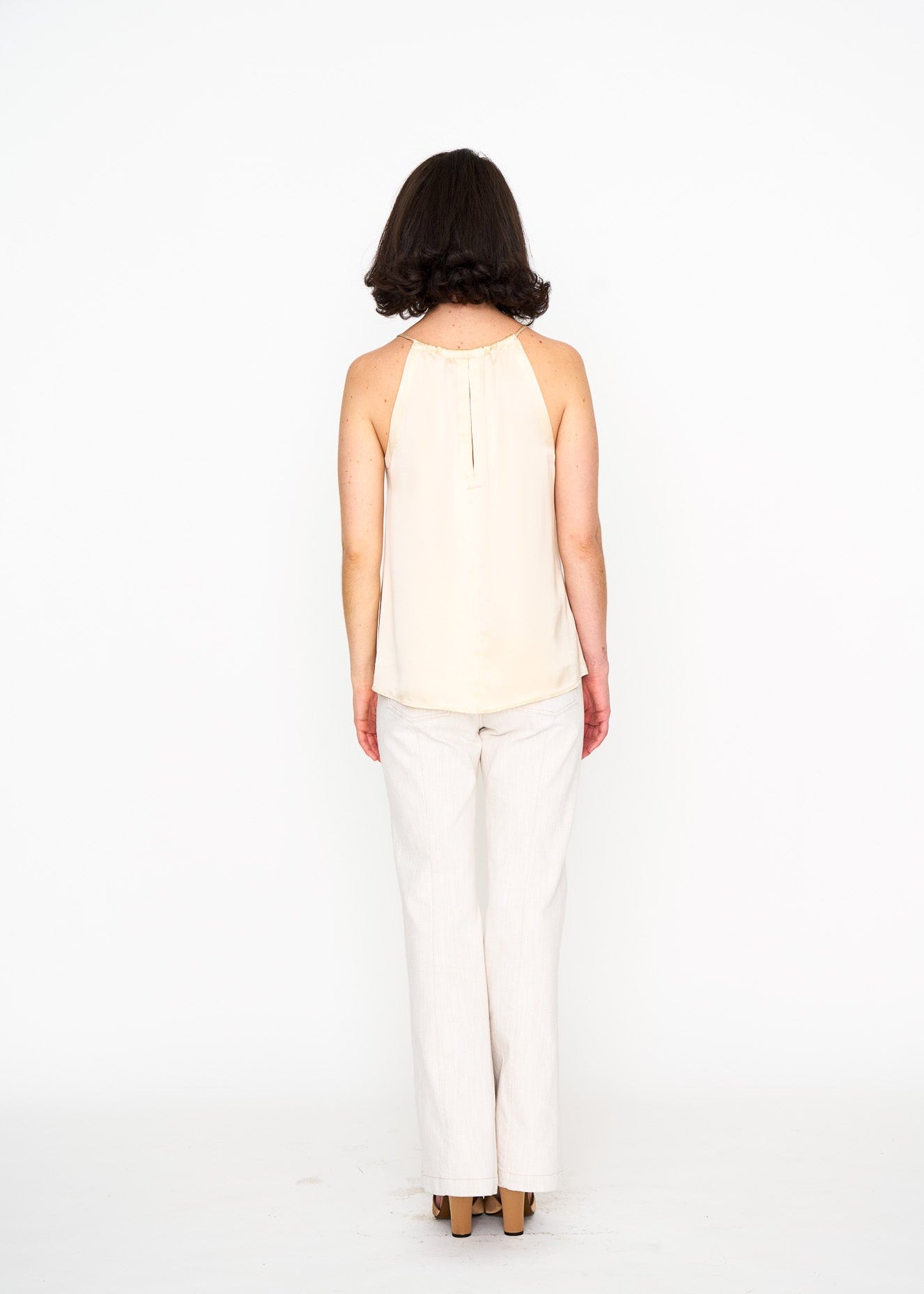 Ecru Satin Halter Top shown on model, back view