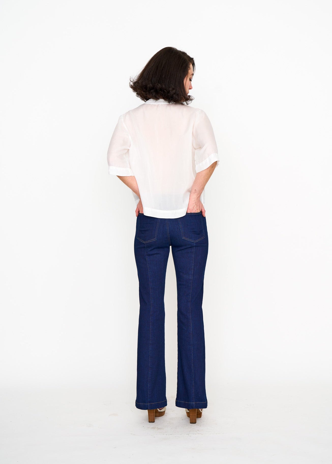White Silk Tee shown on model, close-up detail