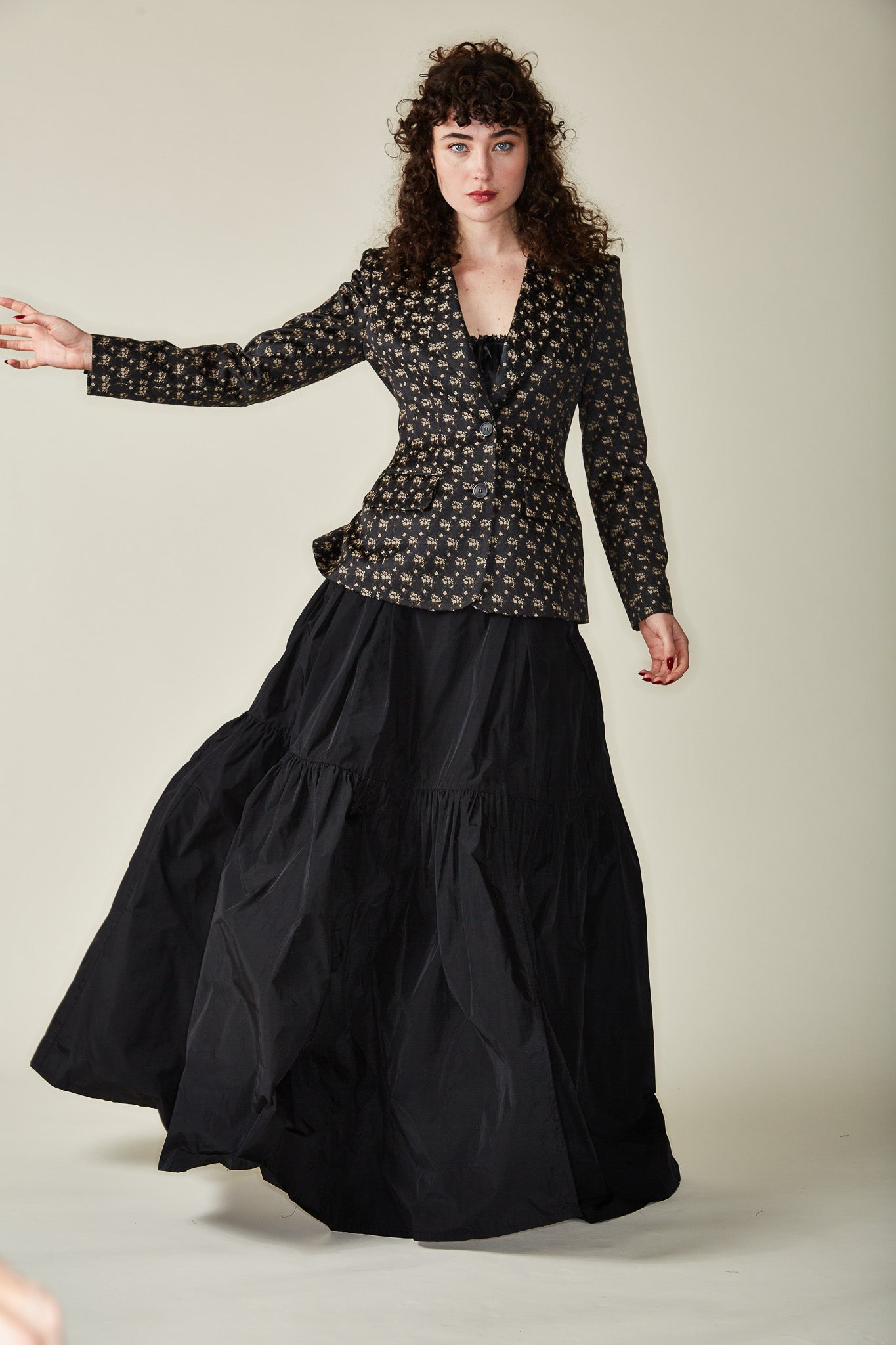 long tiered black skirt with a fitted jacket