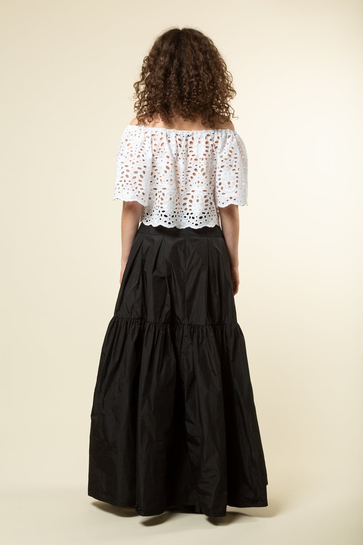 Off the shoulder eyelet top over a black ball skirt