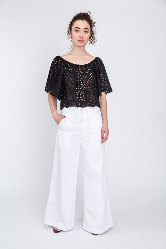 Black cotton eyelet top over white pants