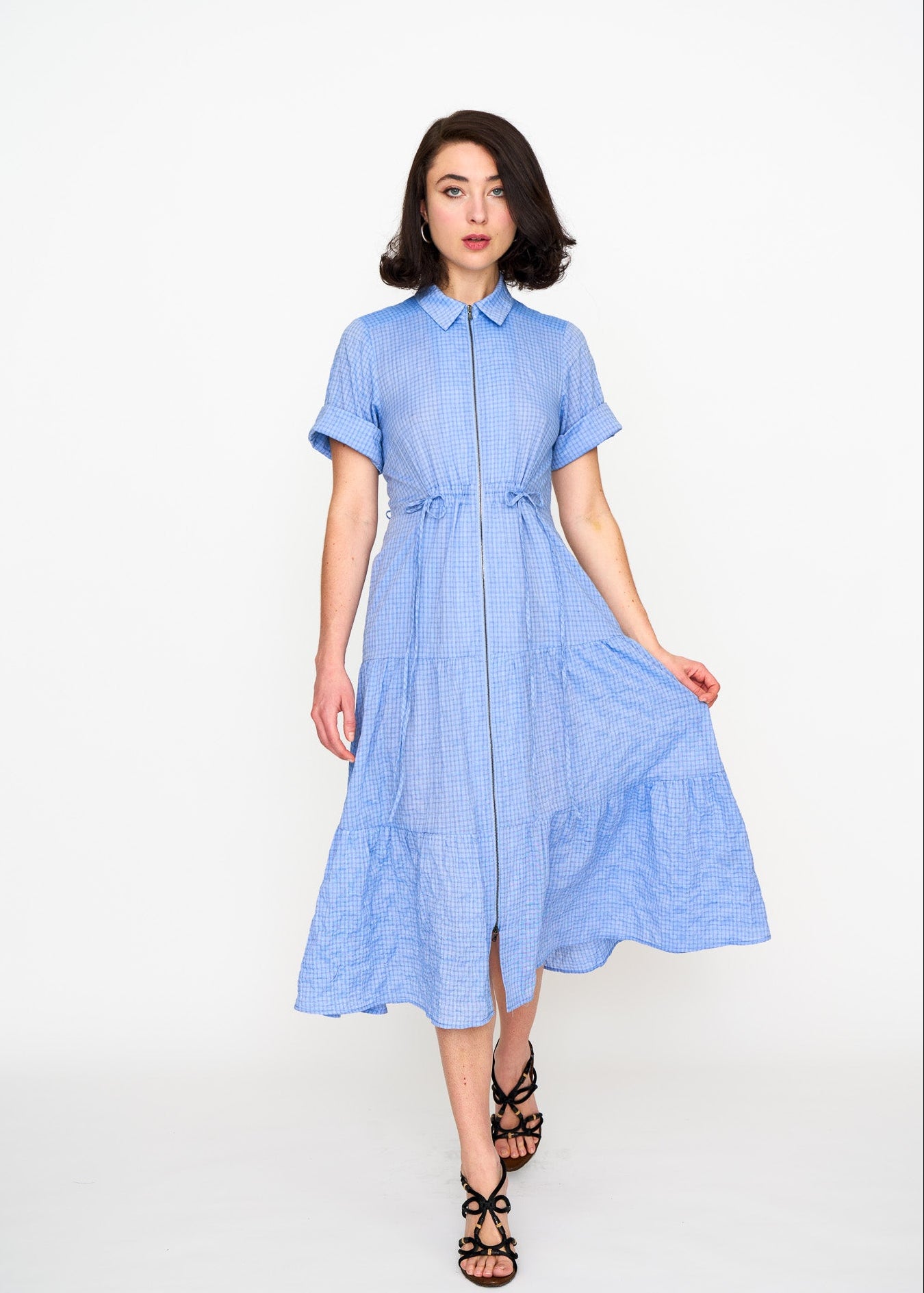 Woman wearing a light blue shirt dress