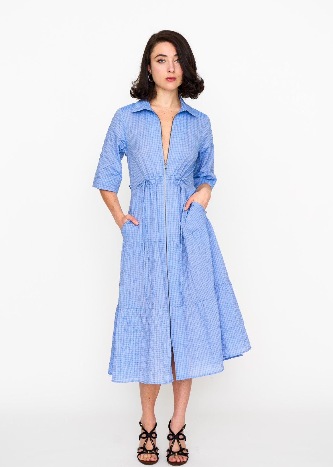 Woman wearing a light blue summer weight dress with pockets
